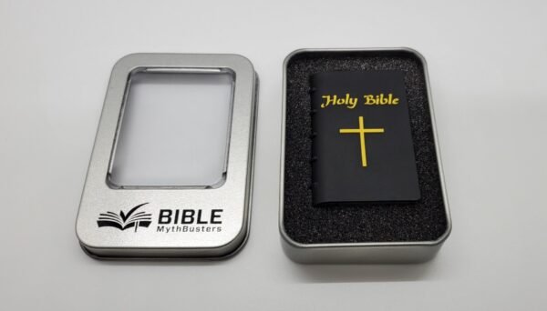A small black "Hope Drive: Seminar Files and Audio Bible" with a yellow cross and title sits in a foam-lined tin. The metal lid, engraved with "BIBLE MythBusters" and an open-book icon, has a clear window and rests beside it on a white surface.